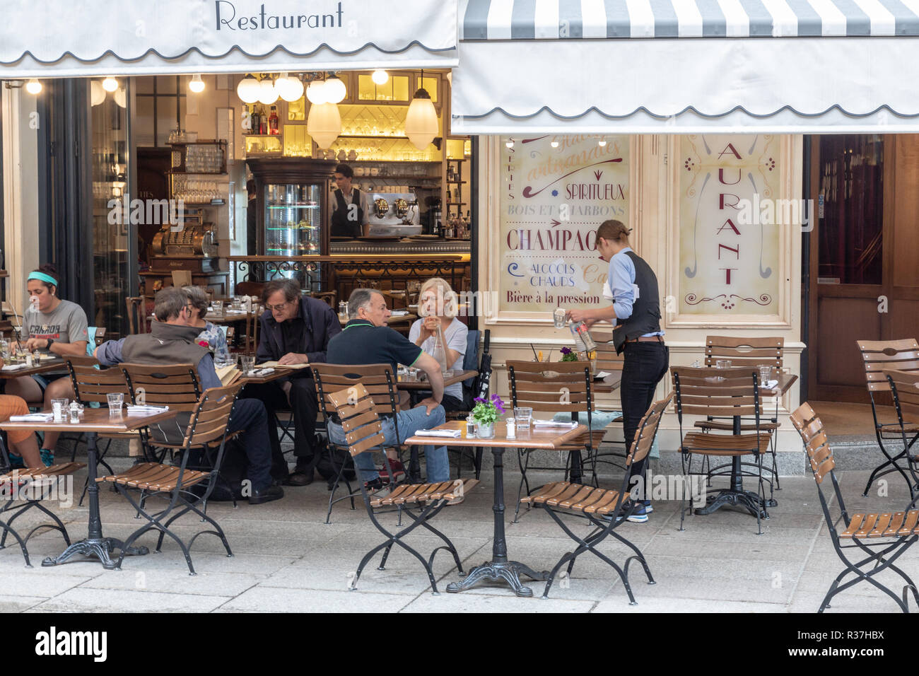 French cafe of the traditional style in Chamonix. People are sittng outside at tables eating and drinking.  Cafe Josephine Stock Photo