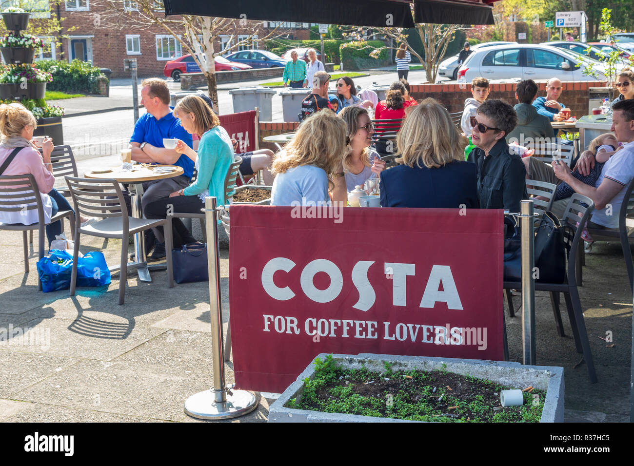 Costa coffee shop in Wilmslow, Customers are sitting outside eating and drinking on a sunny spring day. Stock Photo