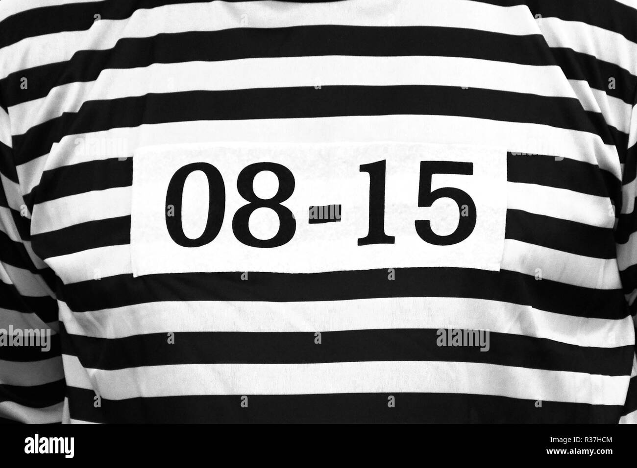 black white striped prisoner clothes top with standard id number 0815 Stock Photo