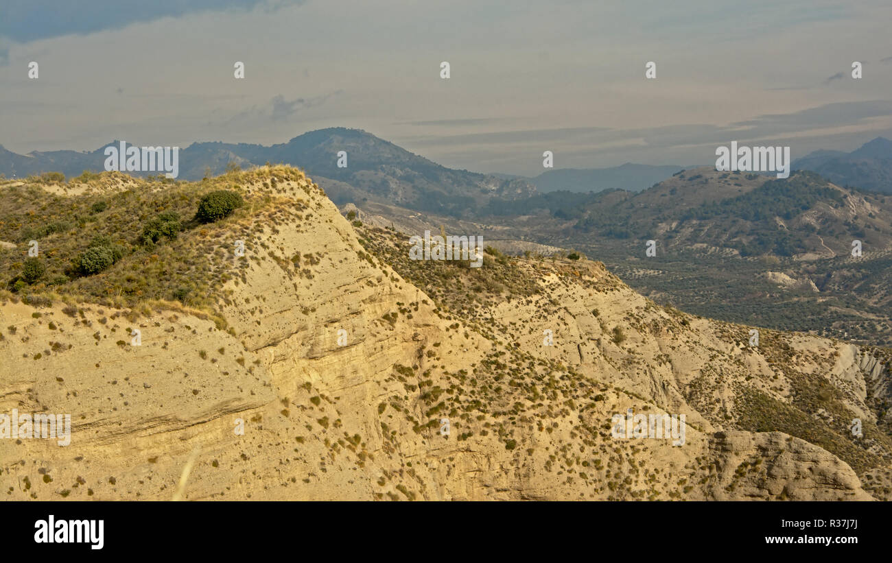 Cliffs of Sierra Nevada mountains on a sunny day with soft clouds, Andalusia, Spain Stock Photo