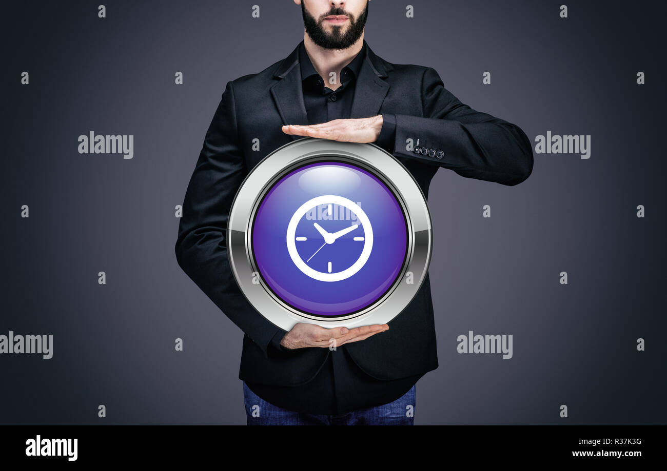 Businessman holding a circle with the symbol of time Stock Photo