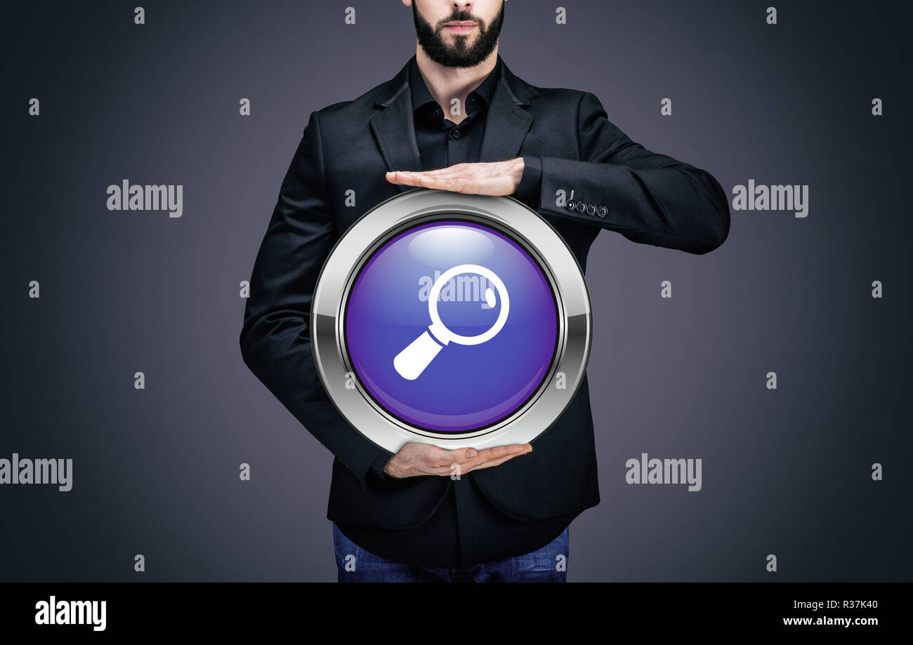Businessman holding a circle with the curved loupe symbol Stock Photo ...