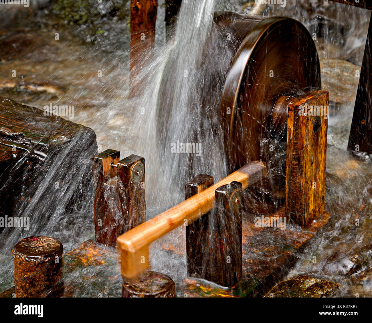 Small waterwheel sculpture on the Wilde Wasser river near Schladming, Austria Stock Photo