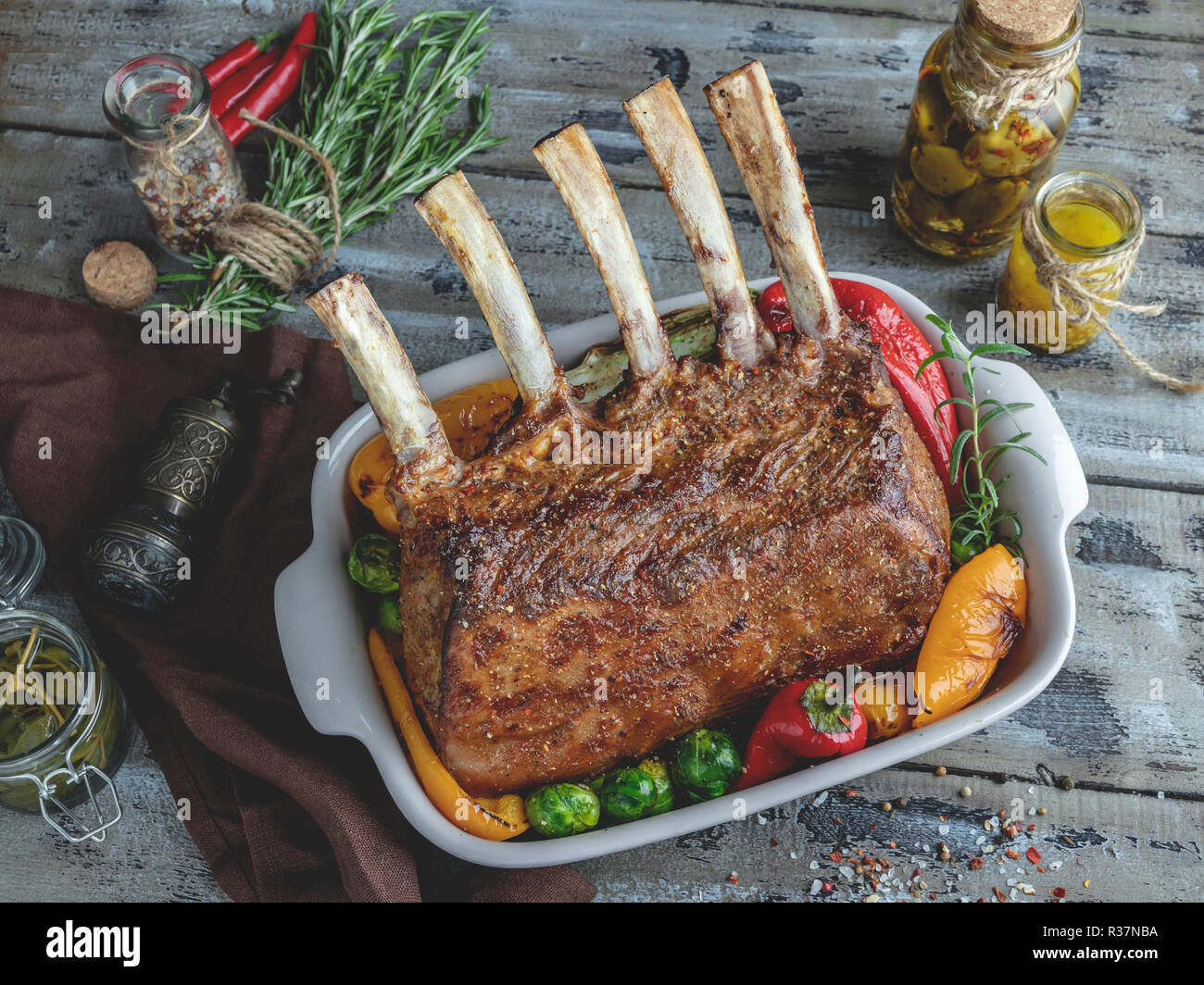 Veal Rack Chops Grilled roasted rack of veal lamb chops with vegetables in ceramic ...