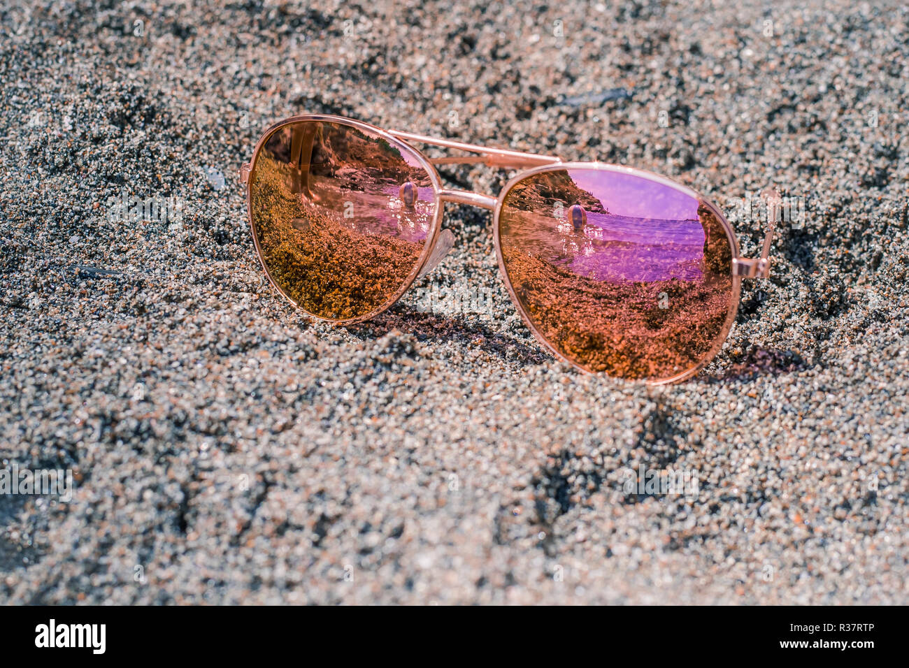 Sunglasses at the beach with beach ball reflection Stock Photo Alamy
