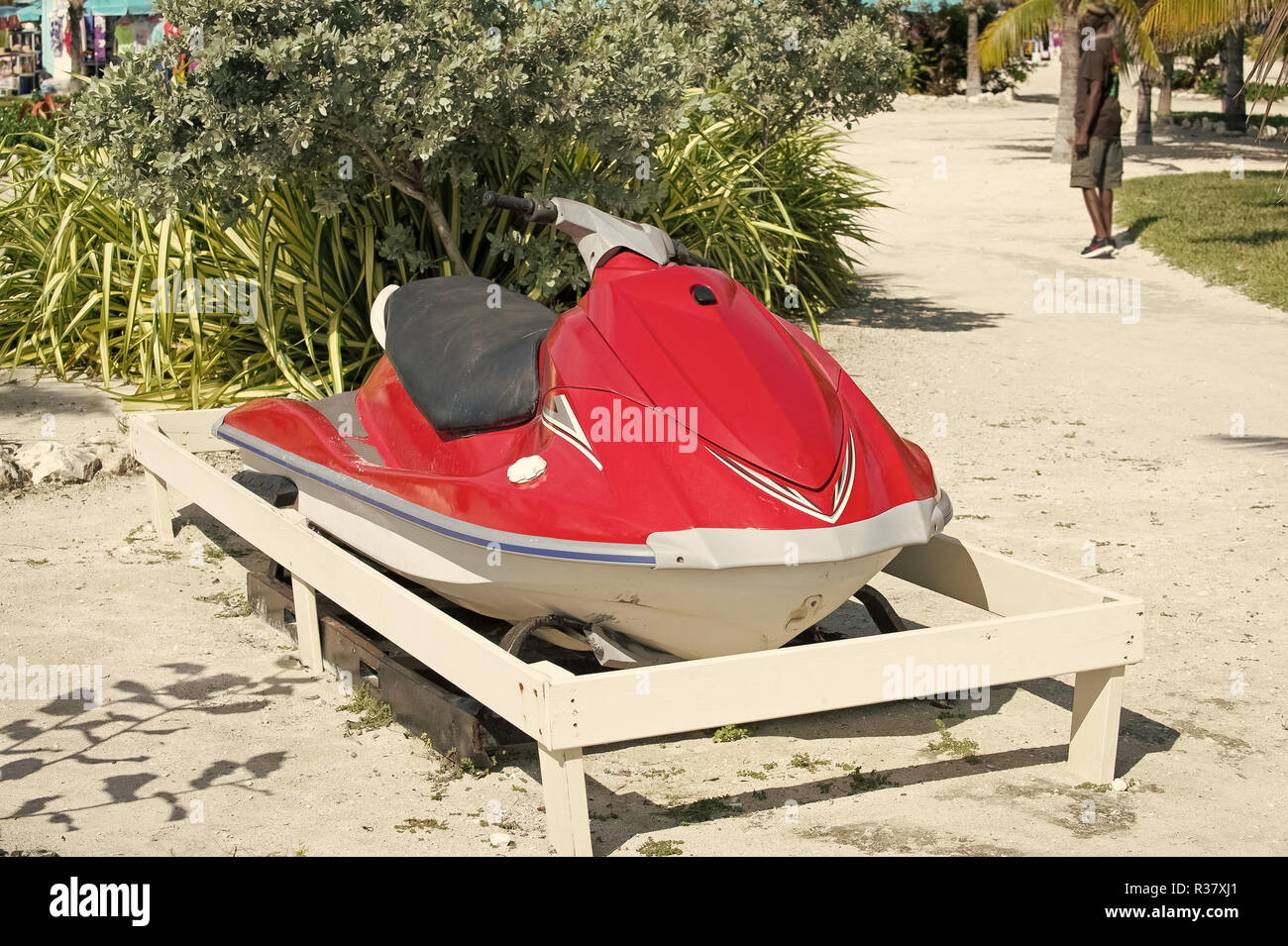 water craft, scooter or jet ski boat, red color motor vessel, parked on ground on sunny day on natural background. Summer vacation. Recreation and sport. Active lifestyle Stock Photo