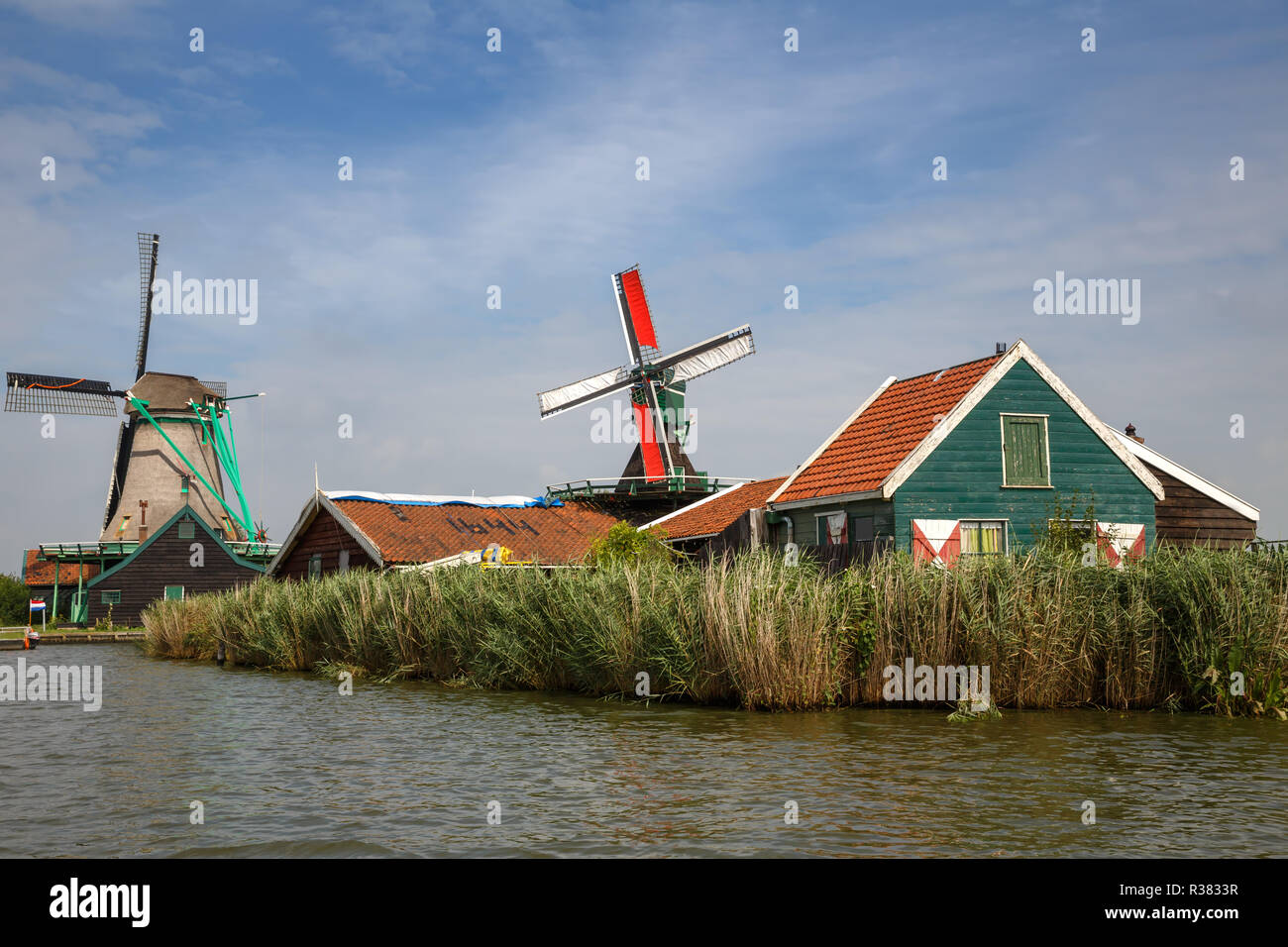 Traditional, authentic dutch windmills at the river Zaam in Zaanse Schans village. Stock Photo