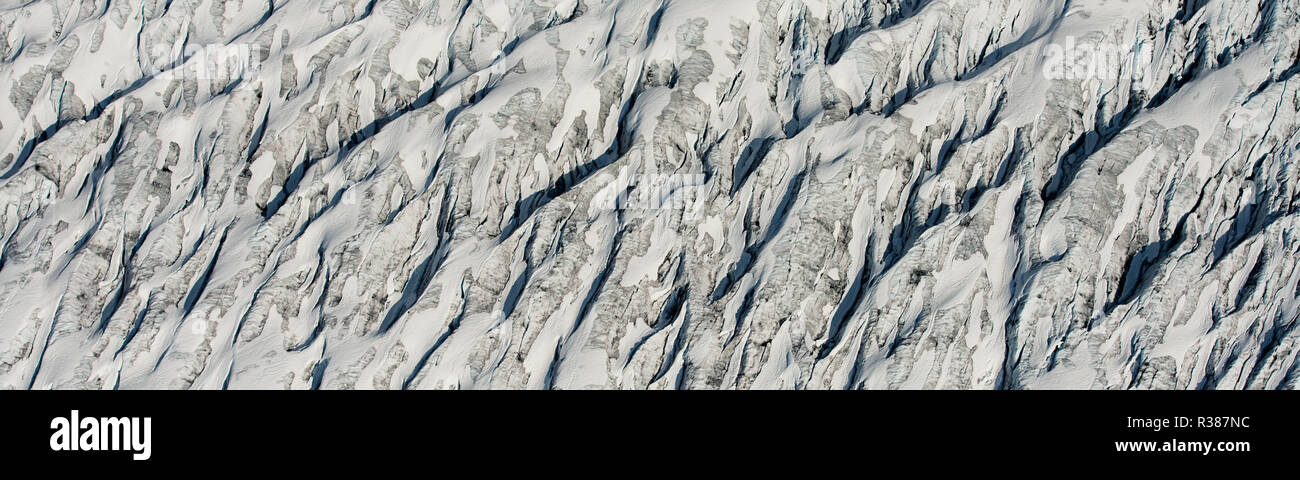 Amazing aerial detail of the Tunsbergdalsbreen glacier, showing the debris and moraine streams going down the glacier.  Tunsbergdalsbreen is a glacier Stock Photo