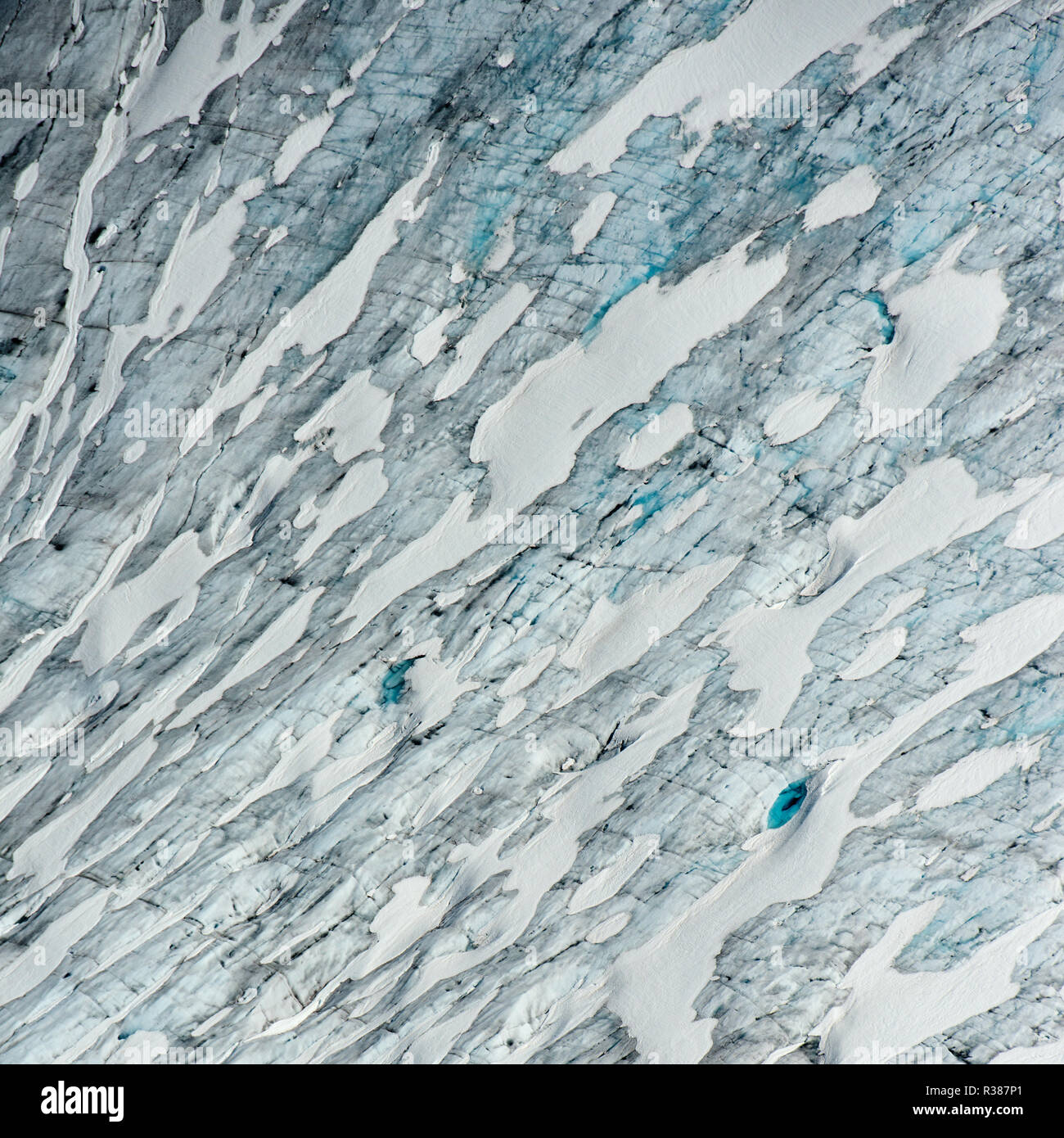 Amazing variations of blue on this aerial image of Tunsbergdalsbreen, Norway's longest glacier arm of the Jostedalsbreen ice cap. Tunsbergdalsbreen is Stock Photo