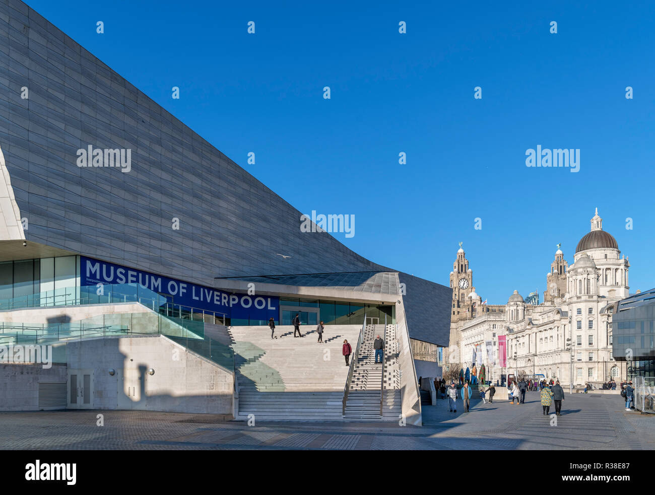 The Museum of Liverpool with the Three Graces behind, Pier Head, Liverpool, Merseyside, England, UK Stock Photo