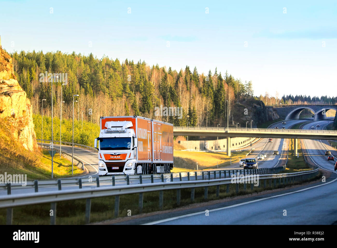 Lohja, Finland - November 18, 2018: Autumnal motorway landscape with cars and MAN TGX 35.580 High Capacity Transport truck for Kesko Logistics. Stock Photo