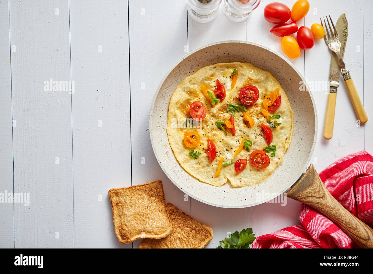 Delicious homemade egg omelette with tomatoes and parsley Stock Photo