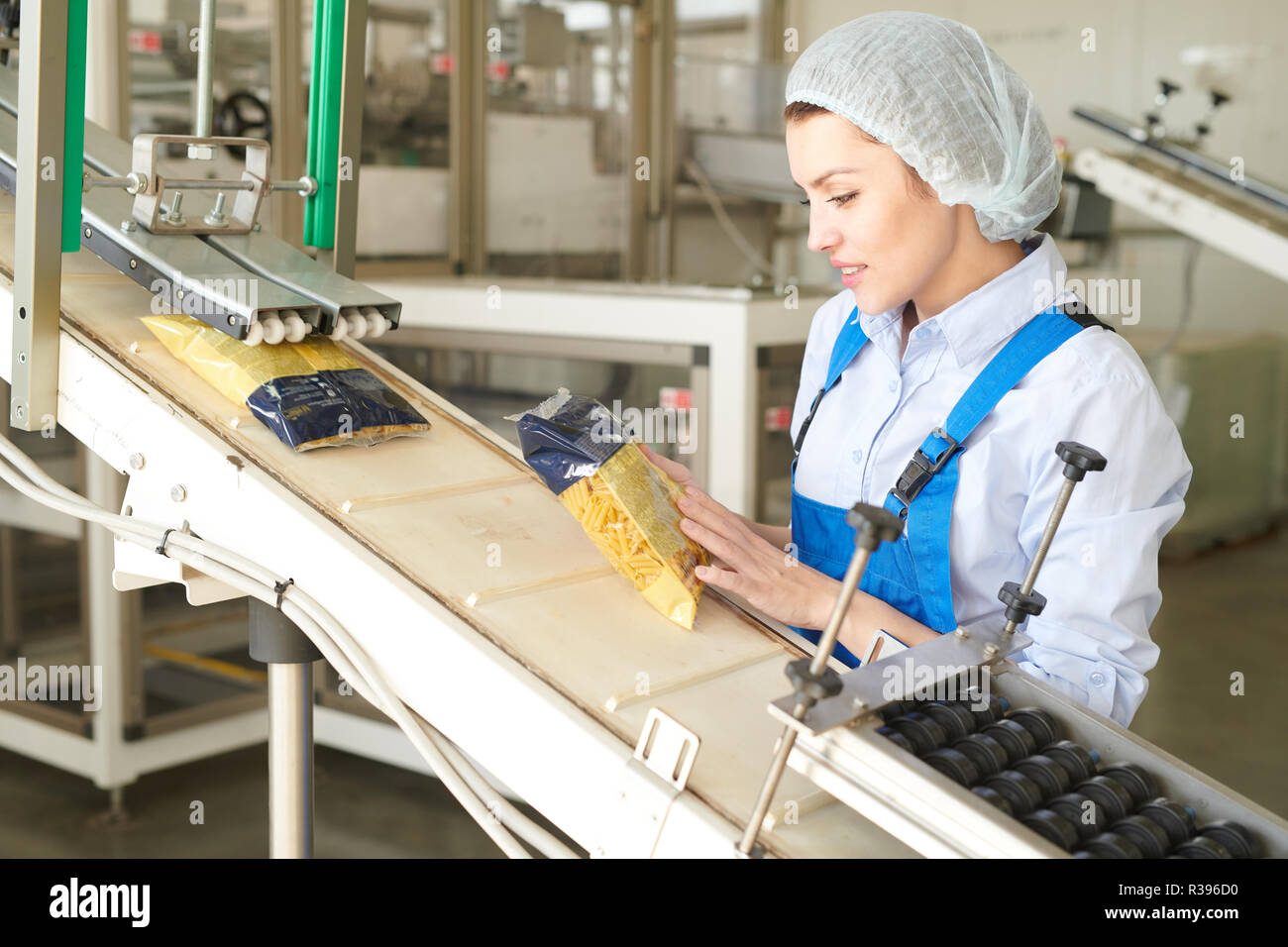 Young  Woman Working at Packaging Line Stock Photo