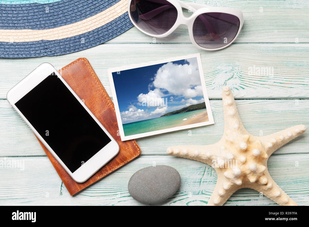 Travel vacation concept with sunglasses, smartphone and weekend photos on wooden backdrop. Top view. Flat lay. All photos taken by me Stock Photo