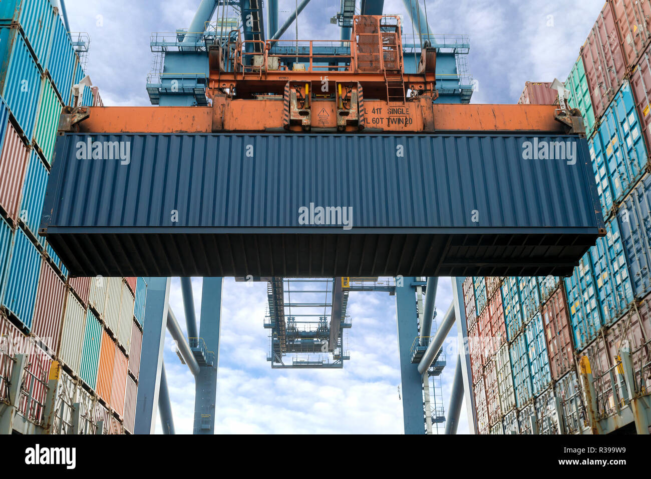 Industrial crane loading Containers in a Cargo freight ship. Container ...