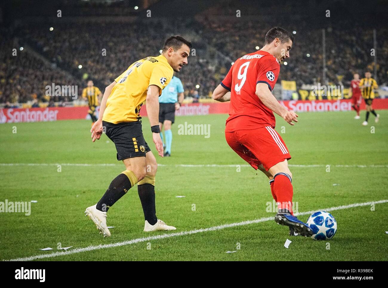 Robert Lewandowski of Bayern Munich and Anastasios Bakasetas of AEK FC are  seen in action during the Group E match of the UEFA Champions League  between AEK FC and Bayern Munich FC