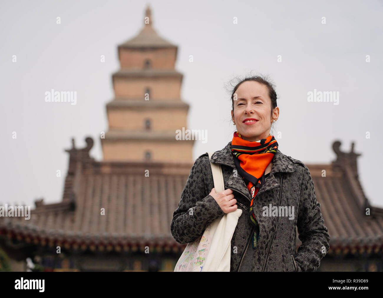 (181122) -- BEIJING, Nov. 22, 2018 (Xinhua) -- Berenice Zandonai, a French national, walks in a square in Xi'an, capital city of northwest China's Shaanxi Province, Oct. 19, 2018. Came to China in 2006 to pursue her Chinese lover she met in France two years ago, Berenice began her career as a designer in a garment company in Shanghai till 2014 when she decided to move to Xi'an to create their own studio to promote cultural exchange between China and France producing illustrations, creative souvenirs and new media, as well as publishing, cinema and theatrical works. (Xinhua/Shao Rui) (clq) Stock Photo