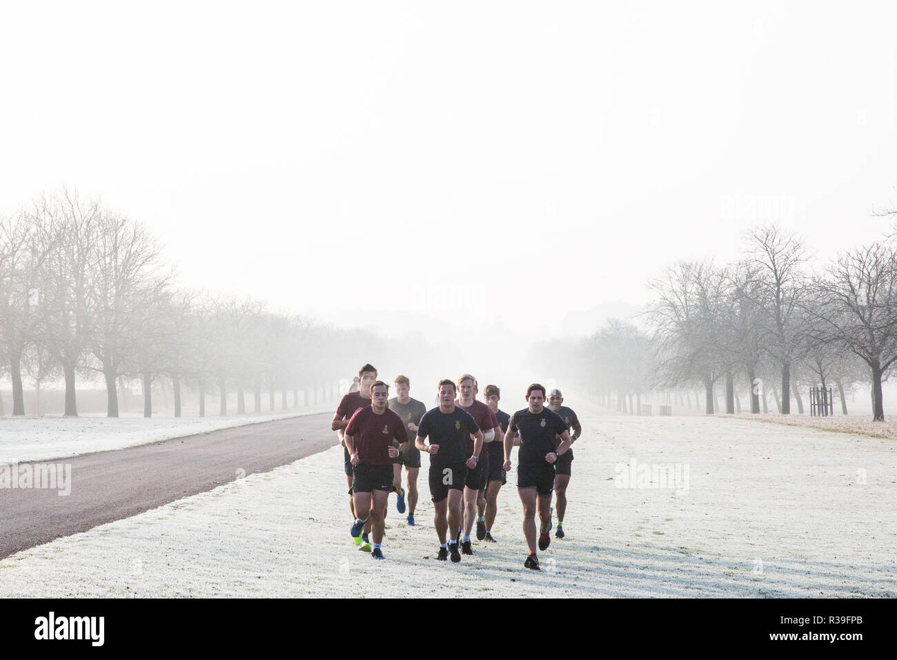 Windsor, UK. 22nd November, 2018. Soldiers train in heavy frost and foggy conditions alongside the Long Walk in Windsor Great Park. After the coldest night since February, there was widespread frost and freezing fog in Berkshire this morning but temperatures are expected to rise for a few days from tomorrow to more normal temperatures for November. Credit: Mark Kerrison/Alamy Live News Stock Photo