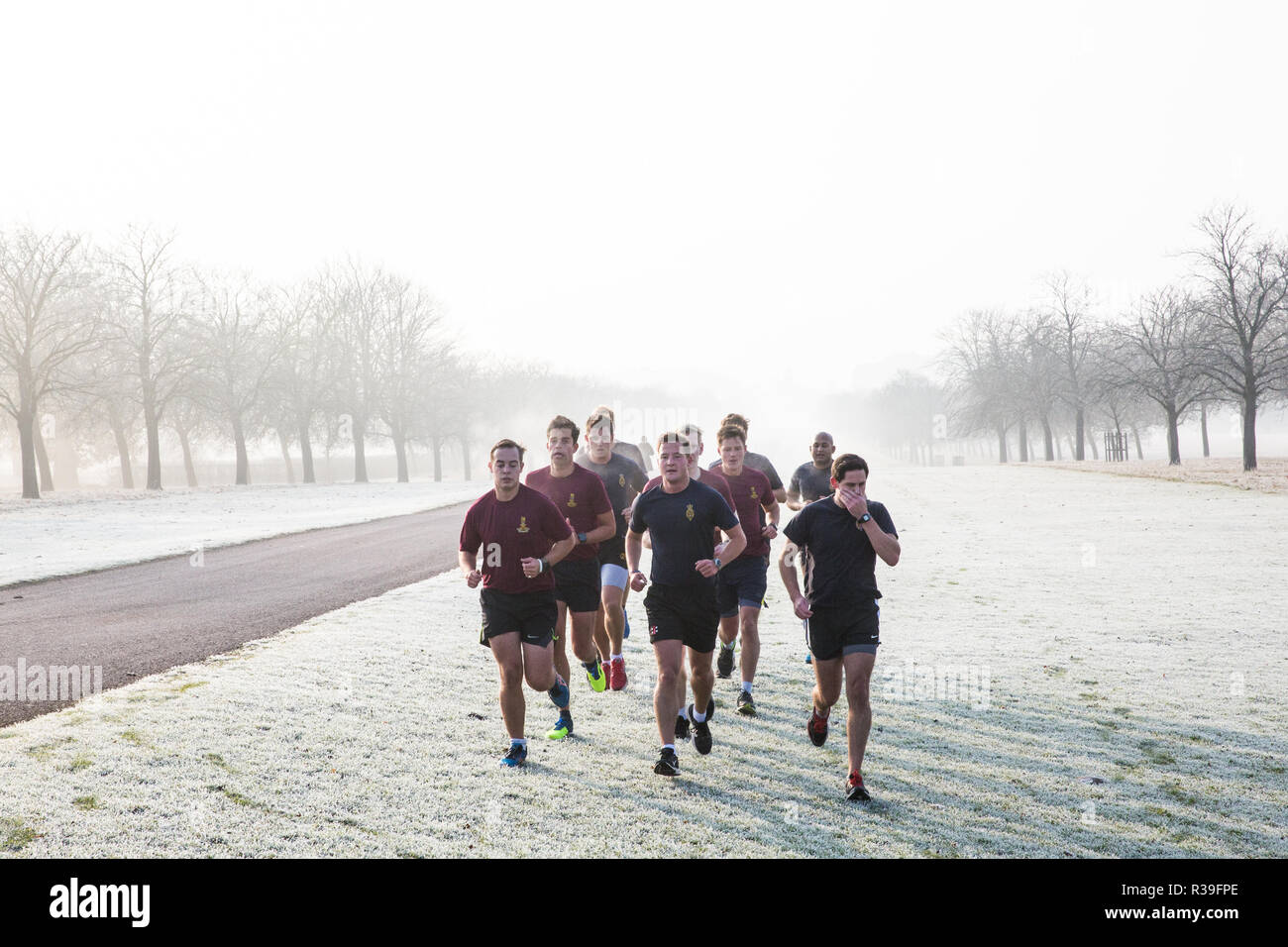 Windsor, UK. 22nd November, 2018. Soldiers train in heavy frost and foggy conditions alongside the Long Walk in Windsor Great Park. After the coldest night since February, there was widespread frost and freezing fog in Berkshire this morning but temperatures are expected to rise for a few days from tomorrow to more normal temperatures for November. Credit: Mark Kerrison/Alamy Live News Stock Photo