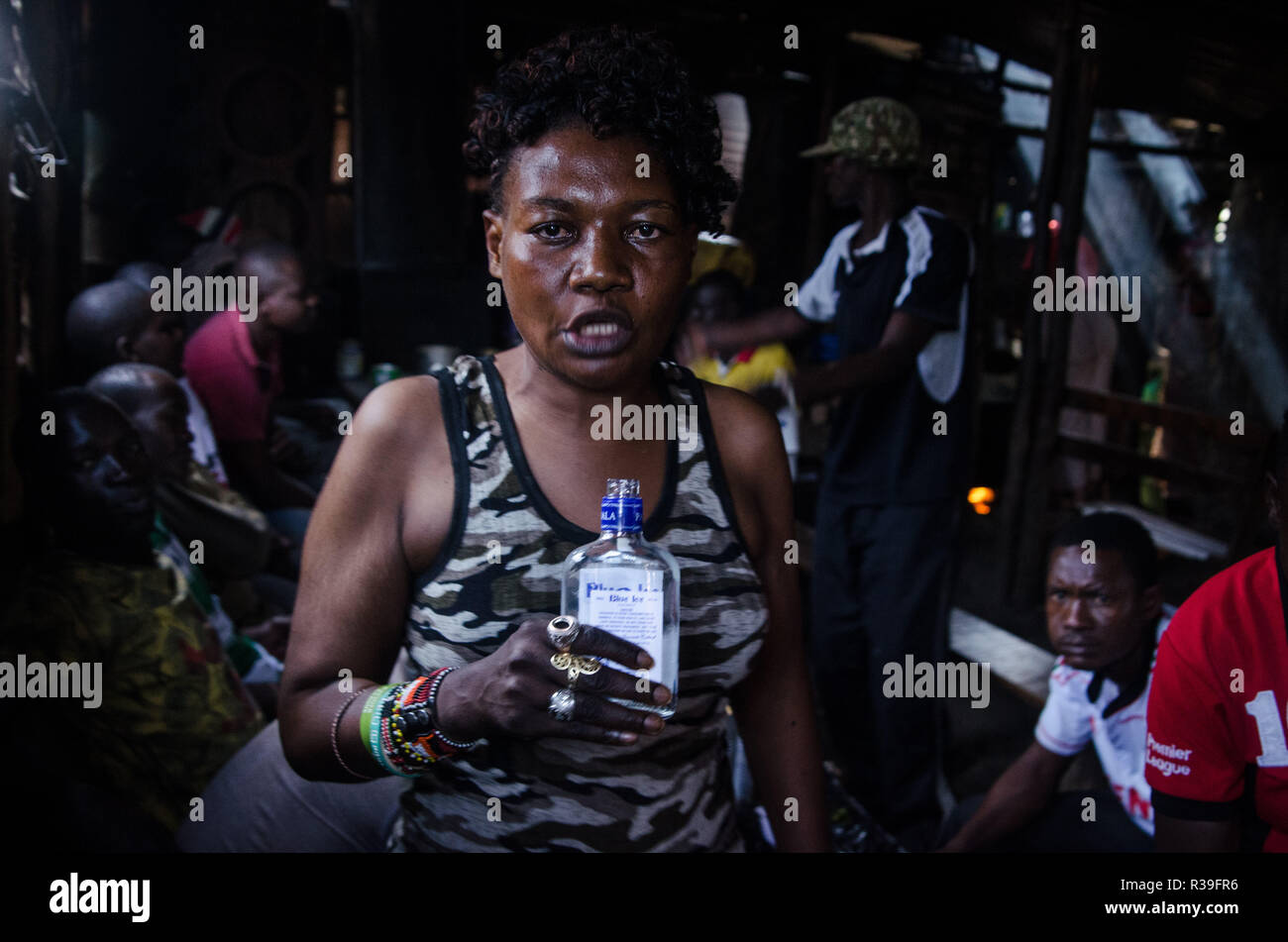 Kenya. 16th Nov, 2018. A woman seen taking alcohol at a local bar.For a long period of time, most women from Kibera slums have been under the influence of Alcohol. Not considering the side effects, women here consume it for different reasons including taking over stress and forgetting about their family problems back home. This is due to lack of enough job opportunities and support from their husbands.The high level of alcohol consumption has led to higher rate of deaths, blindness, and risk of many dangerous diseases such as cancer, hypertension, stroke and traumatic injuries with young Stock Photo