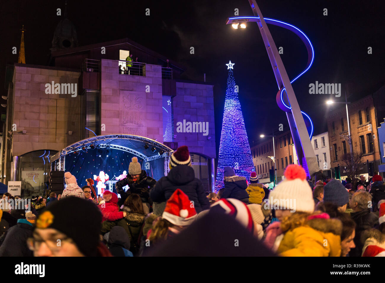 Lisburn, Northern Ireland, 22nd November, 2018. Crowds of people, including many young families, line Bow Street and Market Square in Lisburn city centre to watch a lantern parade involving local schoolchildren accompanied by carnival performers for the annual Christmas Lights Switch-On. It marks the start of Lisburn Light Festival, 22 November - 25 January, when over one million lights will illuminate the city centre. The Mayor, Councillor Uel Mackin switched on the Christmas lights ably assisted by Santa. Credit: Ian Proctor/Alamy Live News Stock Photo