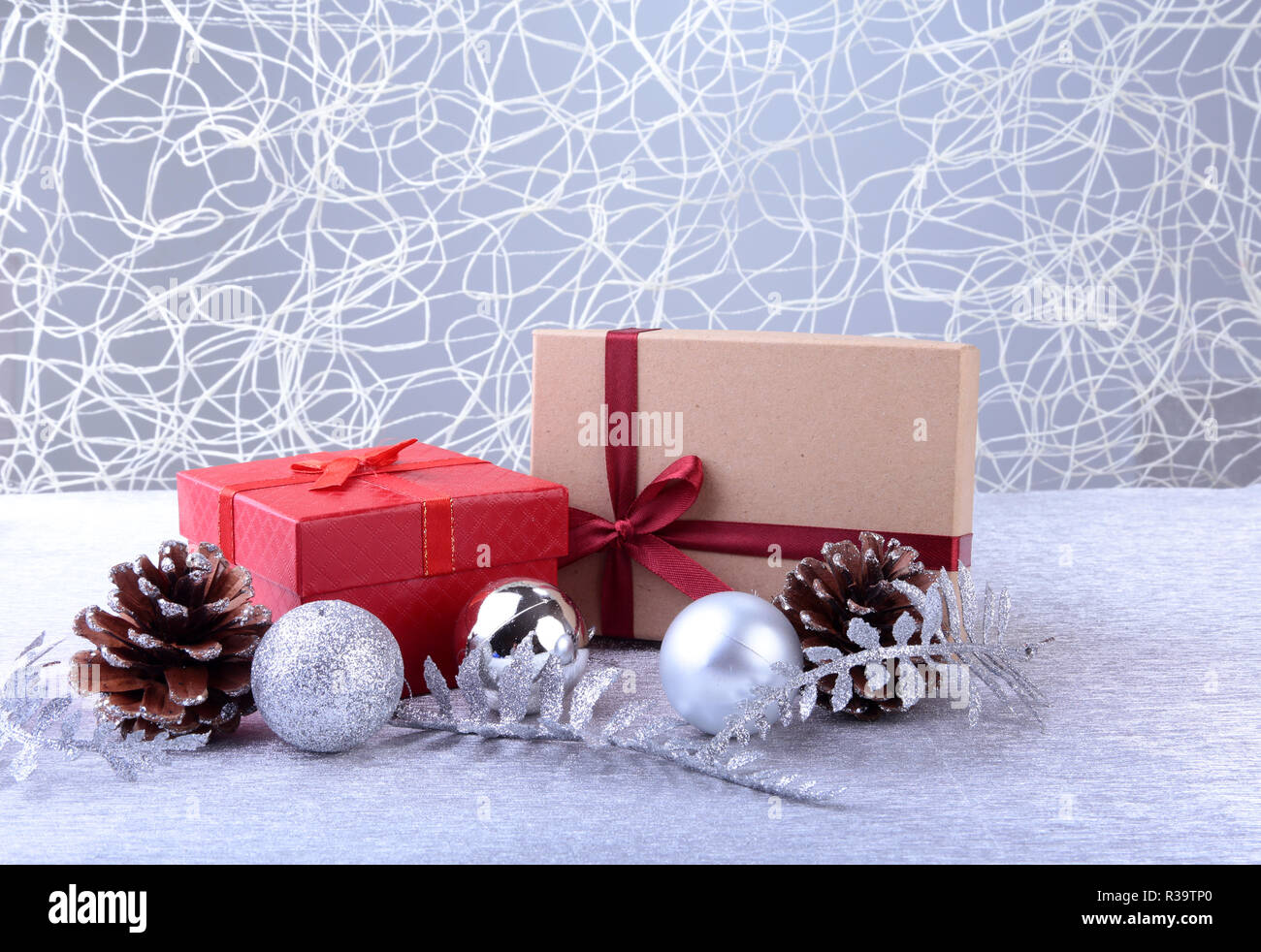 Colorful red gifts with Christmas balls isolated on silver background Stock Photo