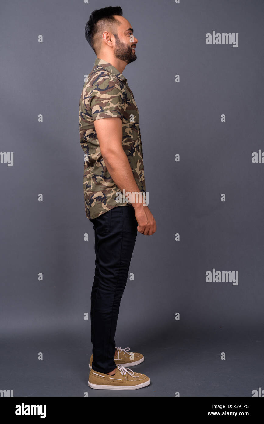 Young bearded Indian man against gray background Stock Photo