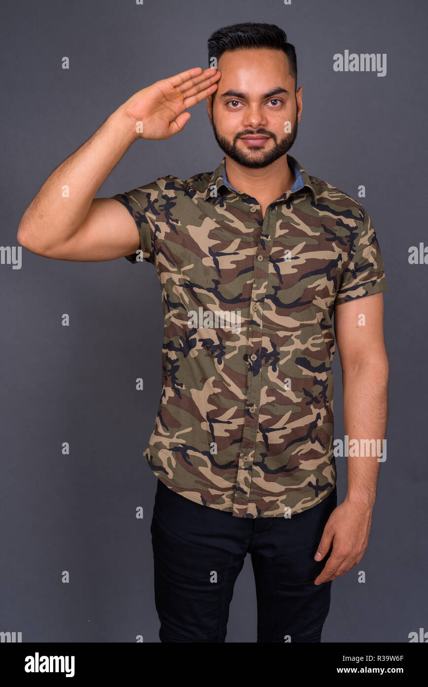 Young bearded Indian man against gray background Stock Photo