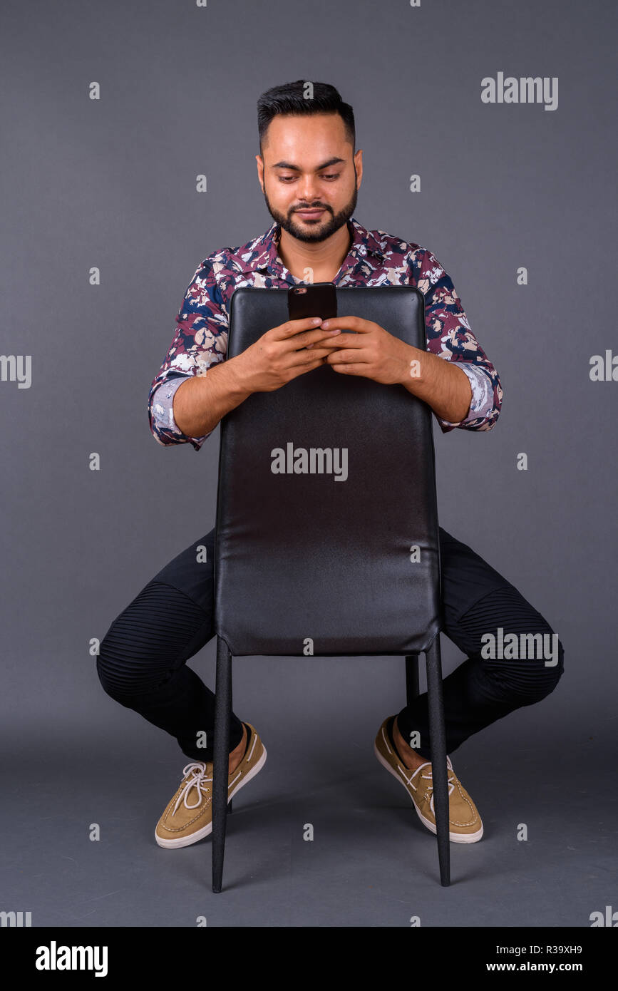 Young bearded Indian man against gray background Stock Photo - Alamy