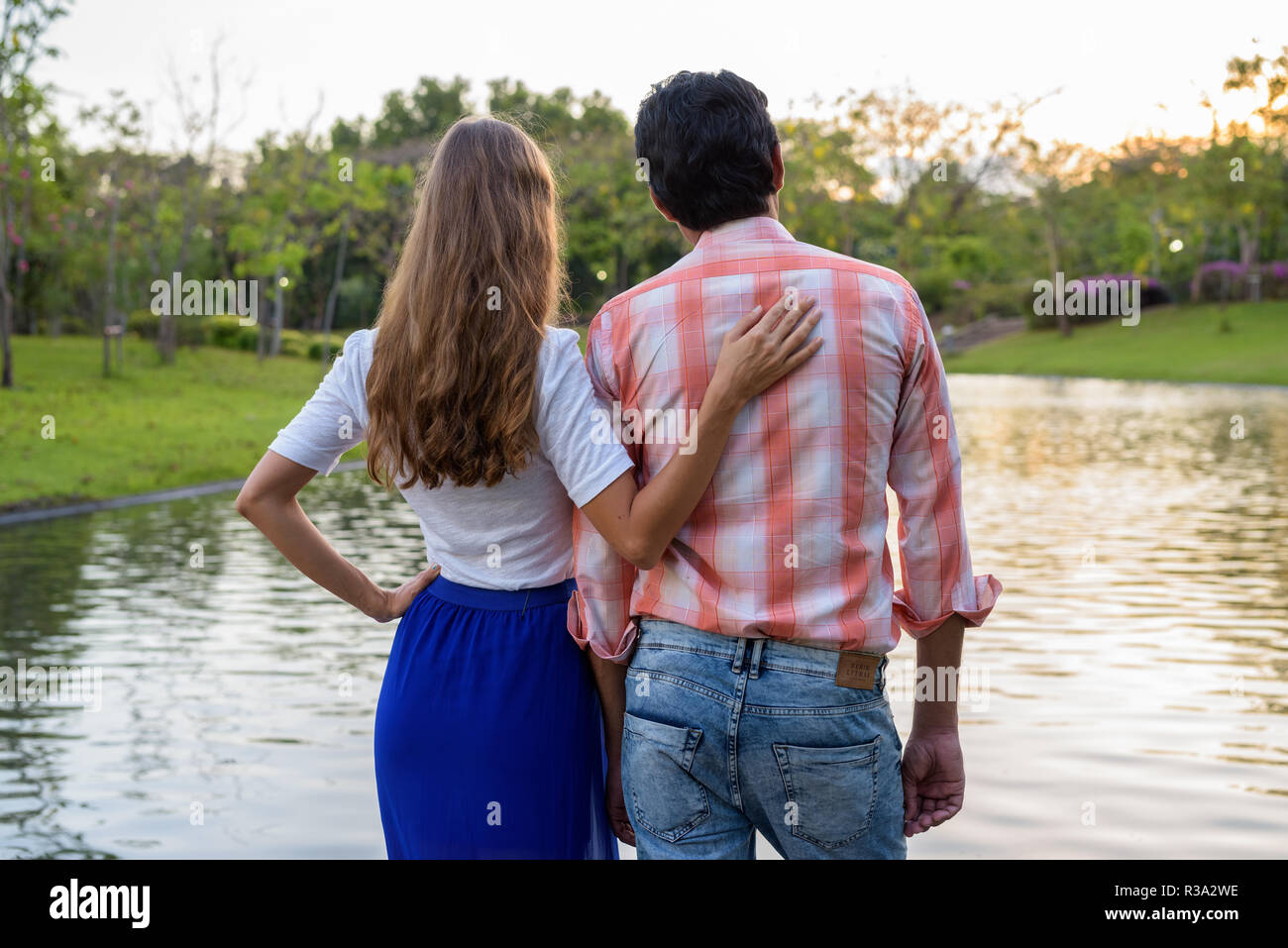 Back view of multi ethnic couple standing and enjoying the sceni Stock Photo