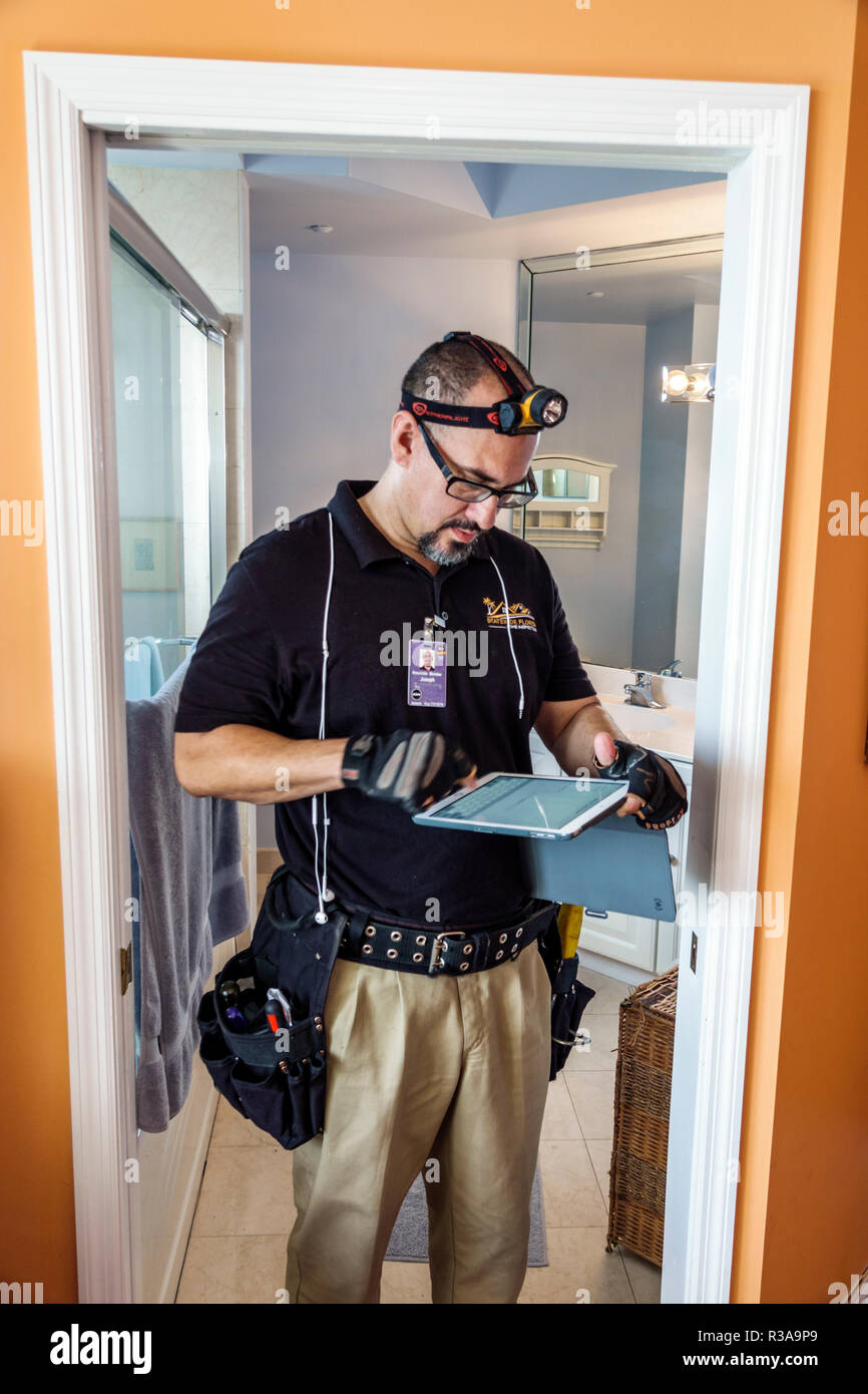 Miami Beach Florida,North Beach,Hispanic man men male,home inspector,using tablet,inspecting condo apartment unit flat,FL181030037 Stock Photo