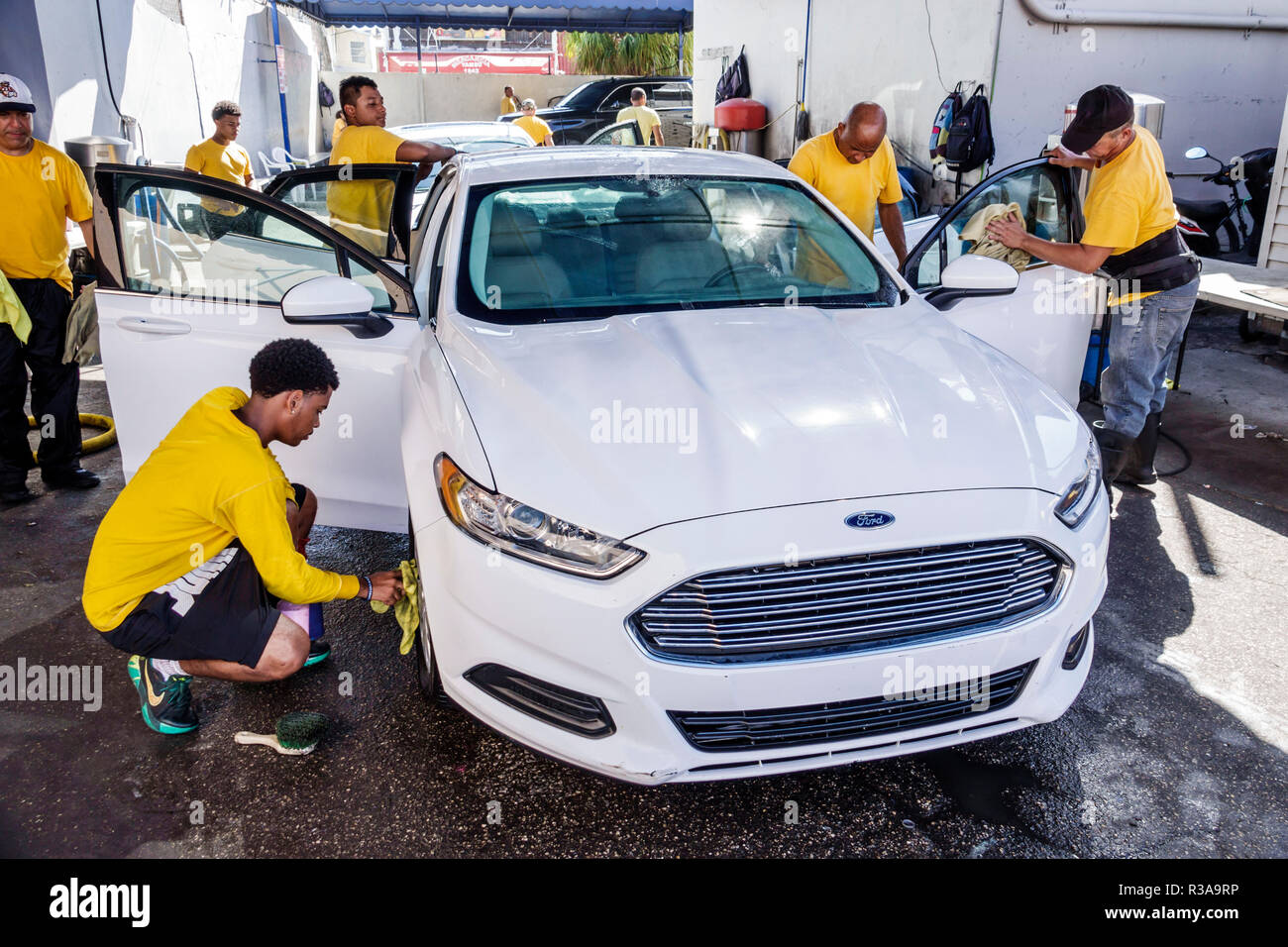 Miami Florida,Little Havana,car wash,white Ford Fusion,Hispanic teen teens teenager teenagers boy boys,male kid kids child children youngster youngste Stock Photo