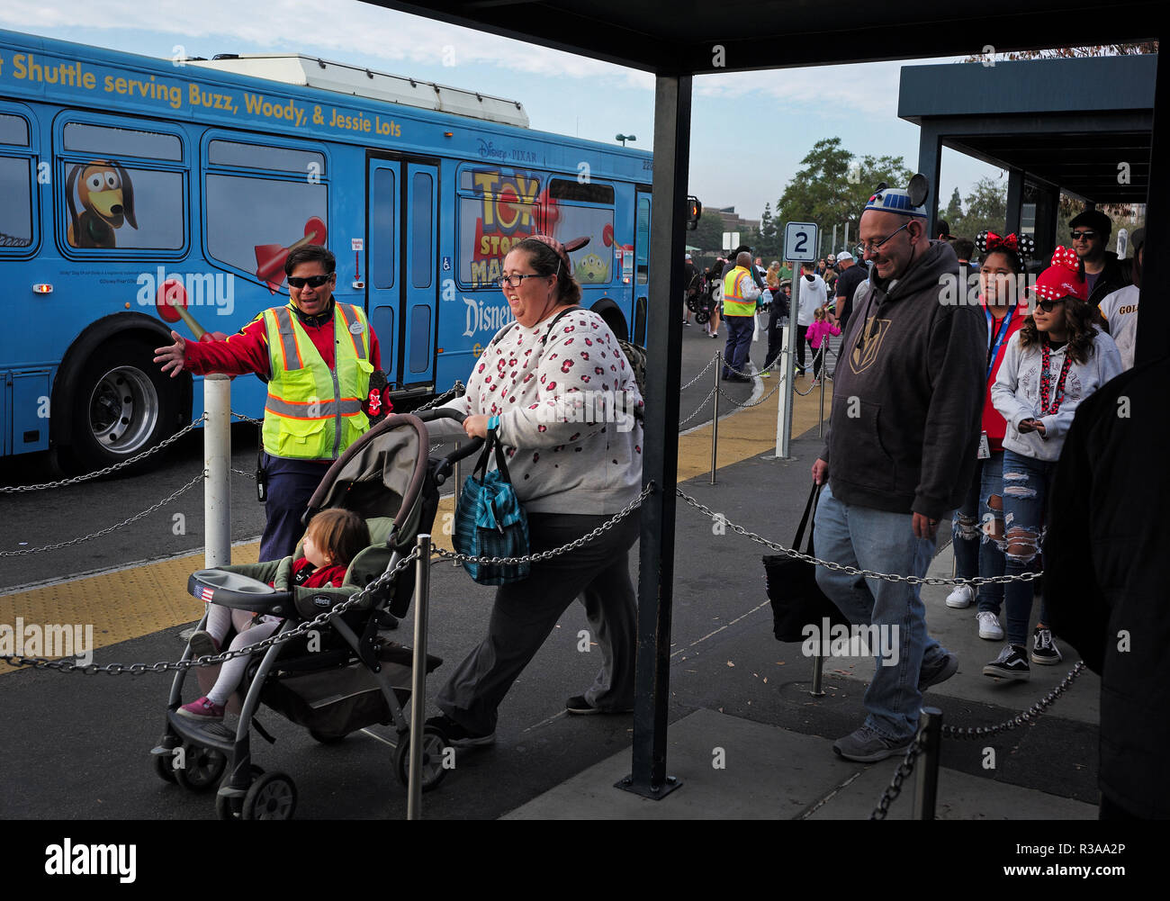 Disneyland guests wait to board a bus in the Woody Toy Story parking lot in Anaheim, CA Stock Photo