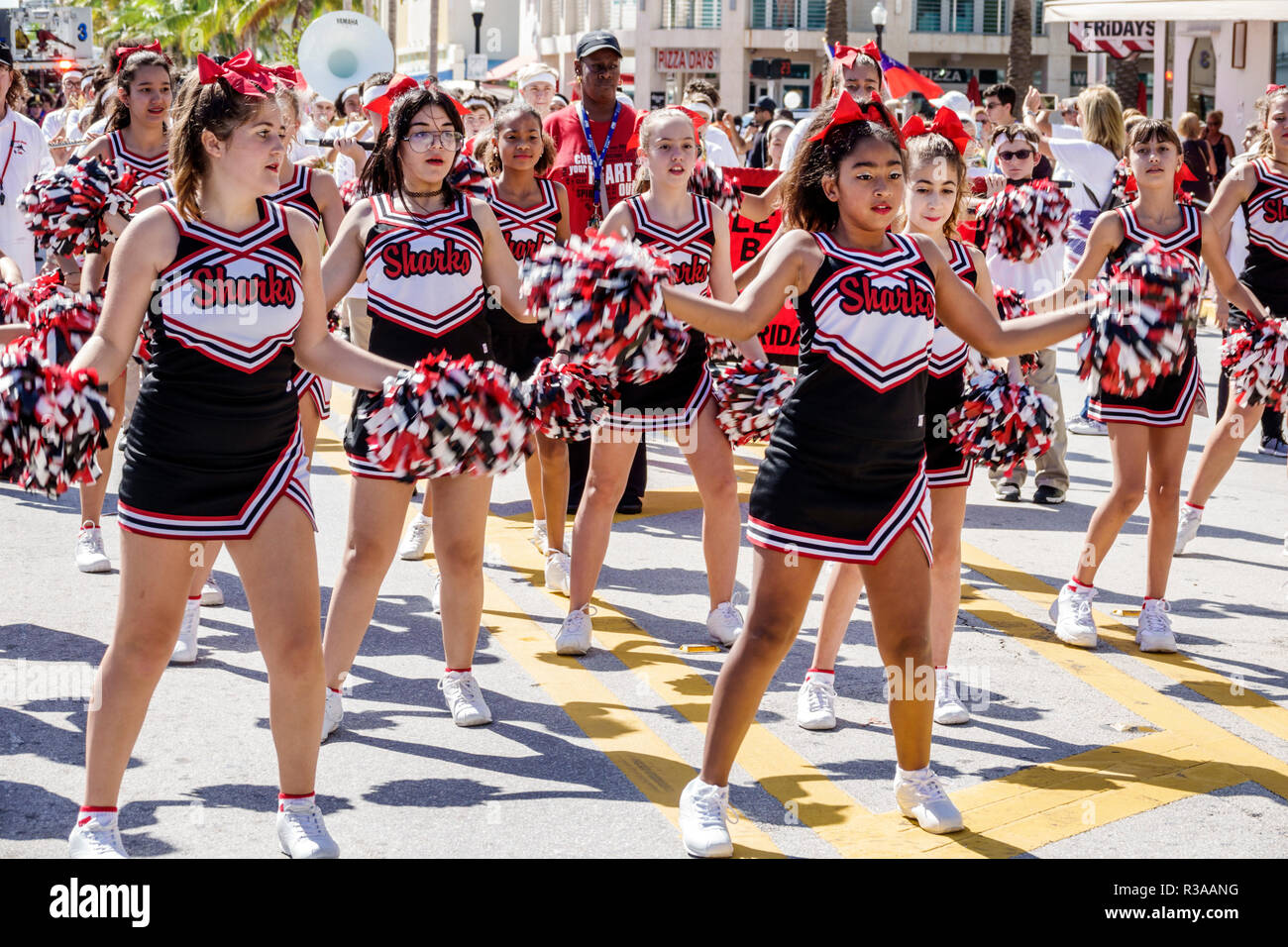 Miami Beach Florida,Ocean Drive,Veterans Day Parade activities,Nautilus Middle School cheerleaders pompom girls Sharks,perform performing,Asian Black Stock Photo