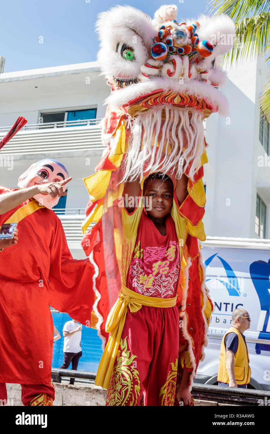 Miami Beach Florida,Ocean Drive,Veterans Day Parade activities,Black boy boys,male kid kids child children youngster,Chinese dragon costume,FL18111505 Stock Photo