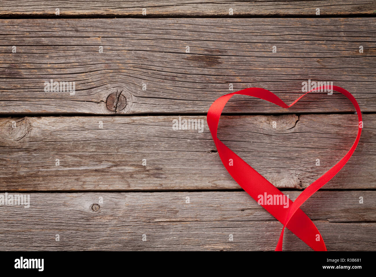 Valentines day greeting card. Heart shaped ribbon over wooden ...