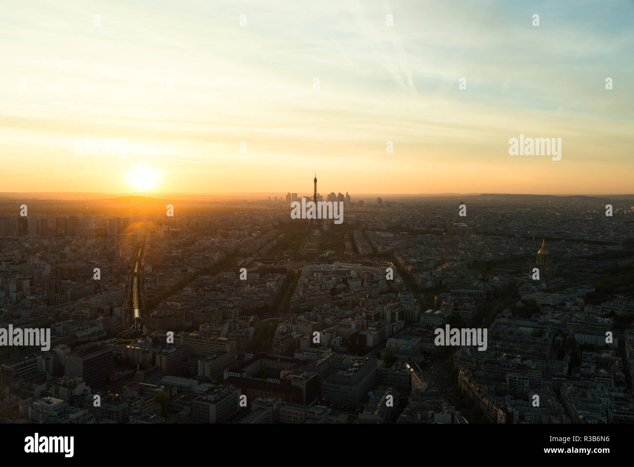 Aerial view of Paris skyline with Eiffel Tower at sunset. Eiffel Tower is one of the most iconic landmarks of Paris, France. Stock Photo