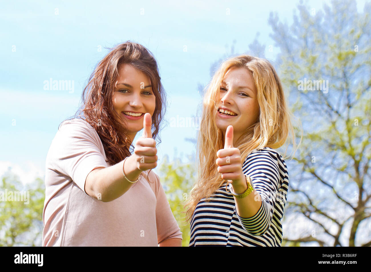 two young women with a thumbs up Stock Photo