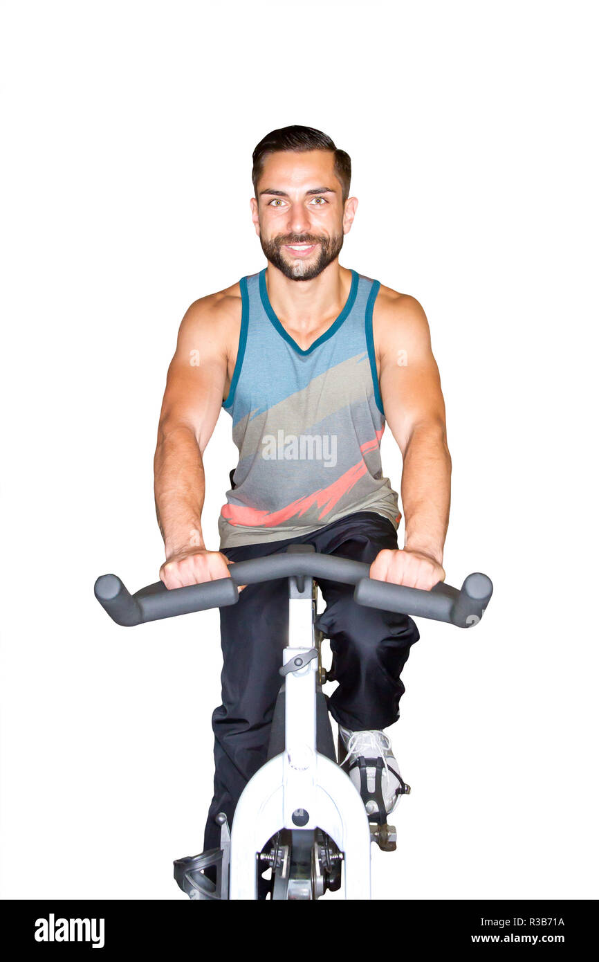 young athletic man on train on the ergometer Stock Photo