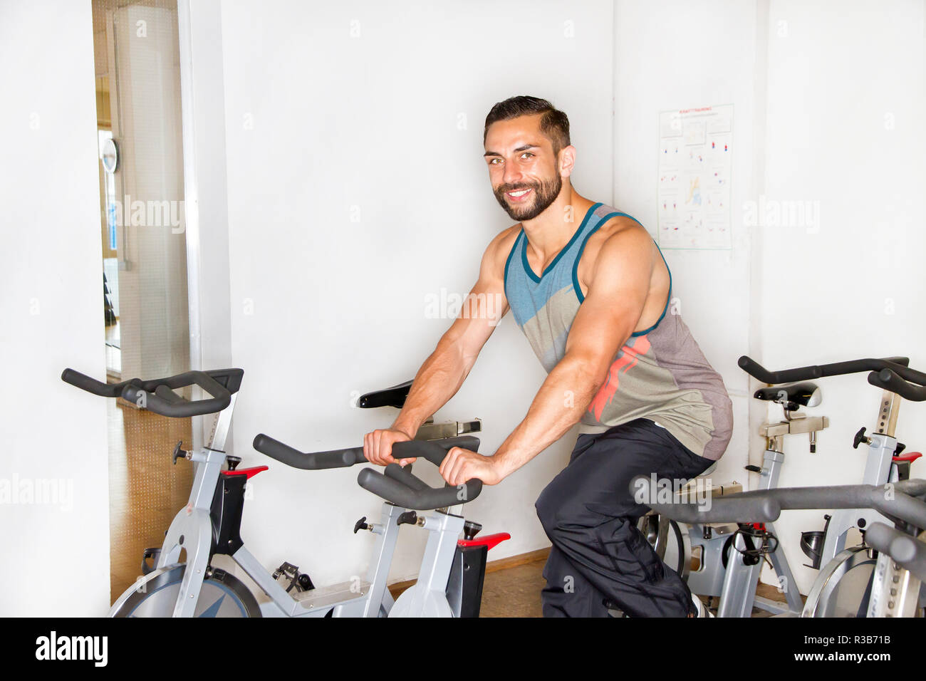 young athletic man on training on the ergometer Stock Photo