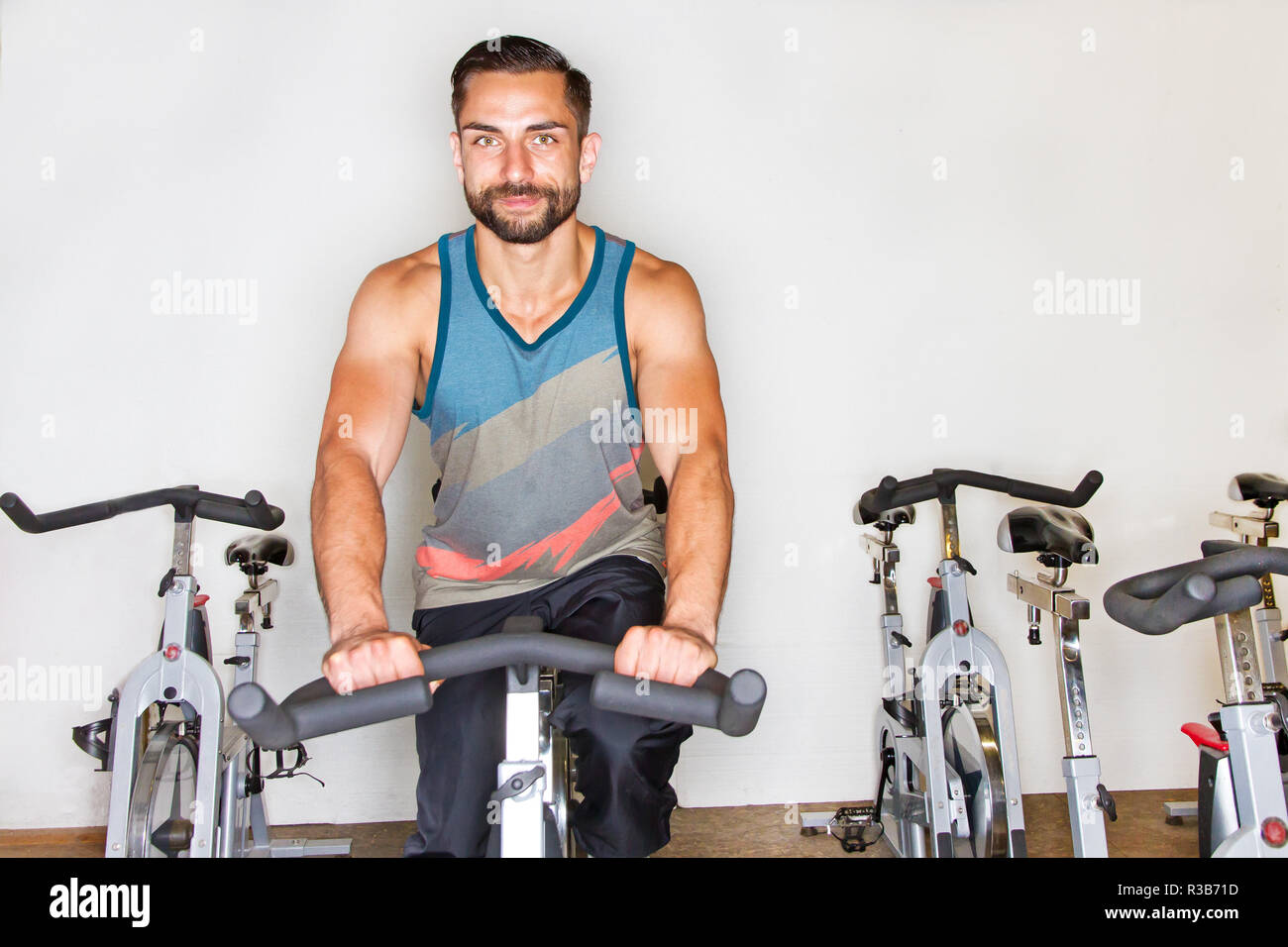 young athletic man on training on the ergometer Stock Photo