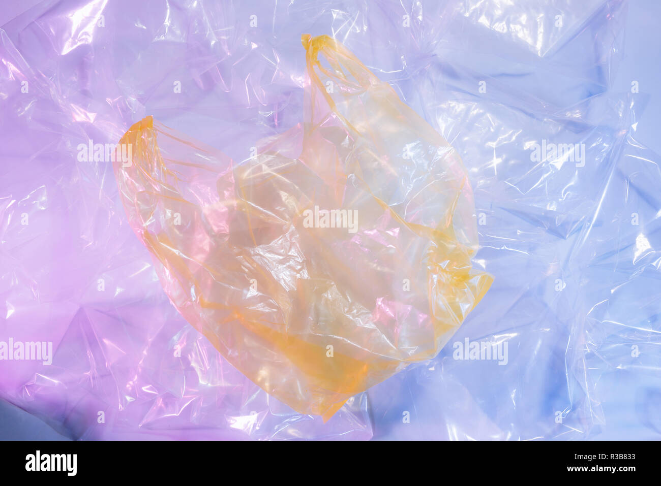 Colorful plastic bag on cement floor background. Stock Photo