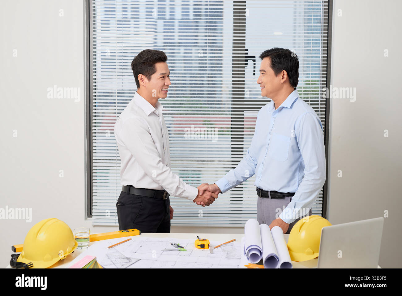 Architects working on plans at office, light effect Stock Photo