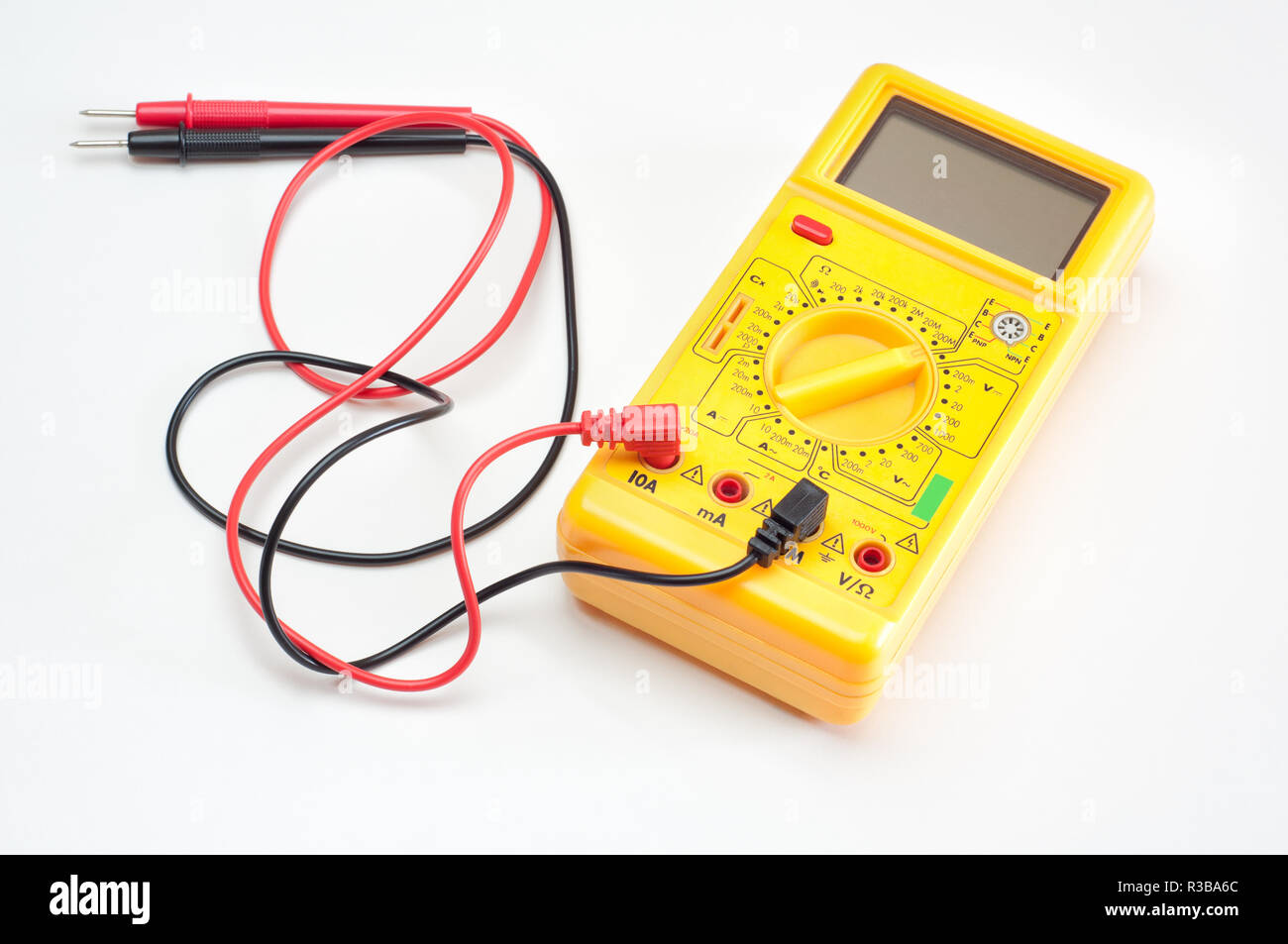 Digital yellow clamp meter with red and black cables, isolated Stock