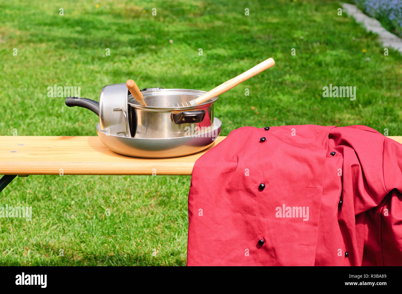 Cookware and chef uniform in the garden, isolated Stock Photo