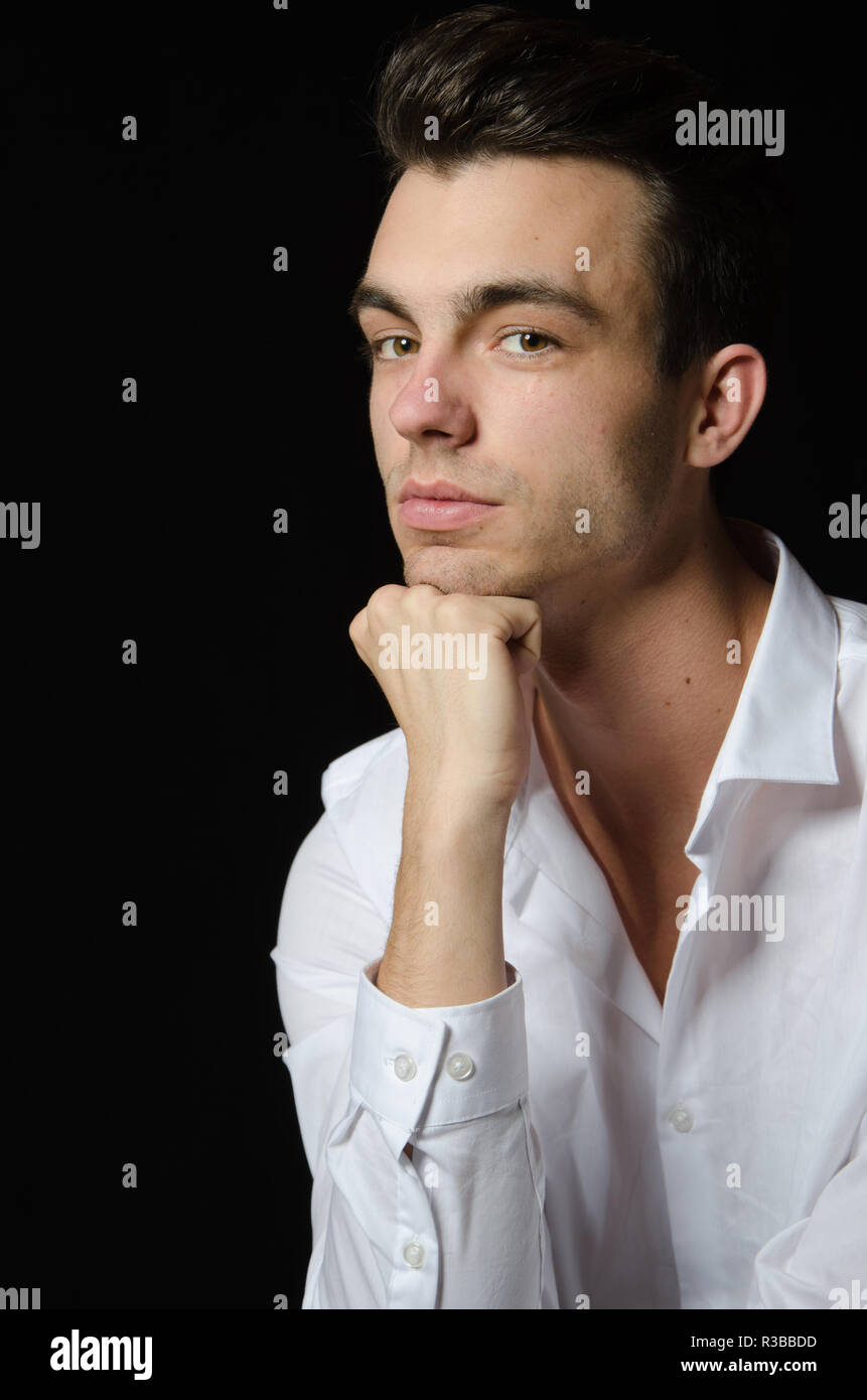young man is resting head on his hand Stock Photo