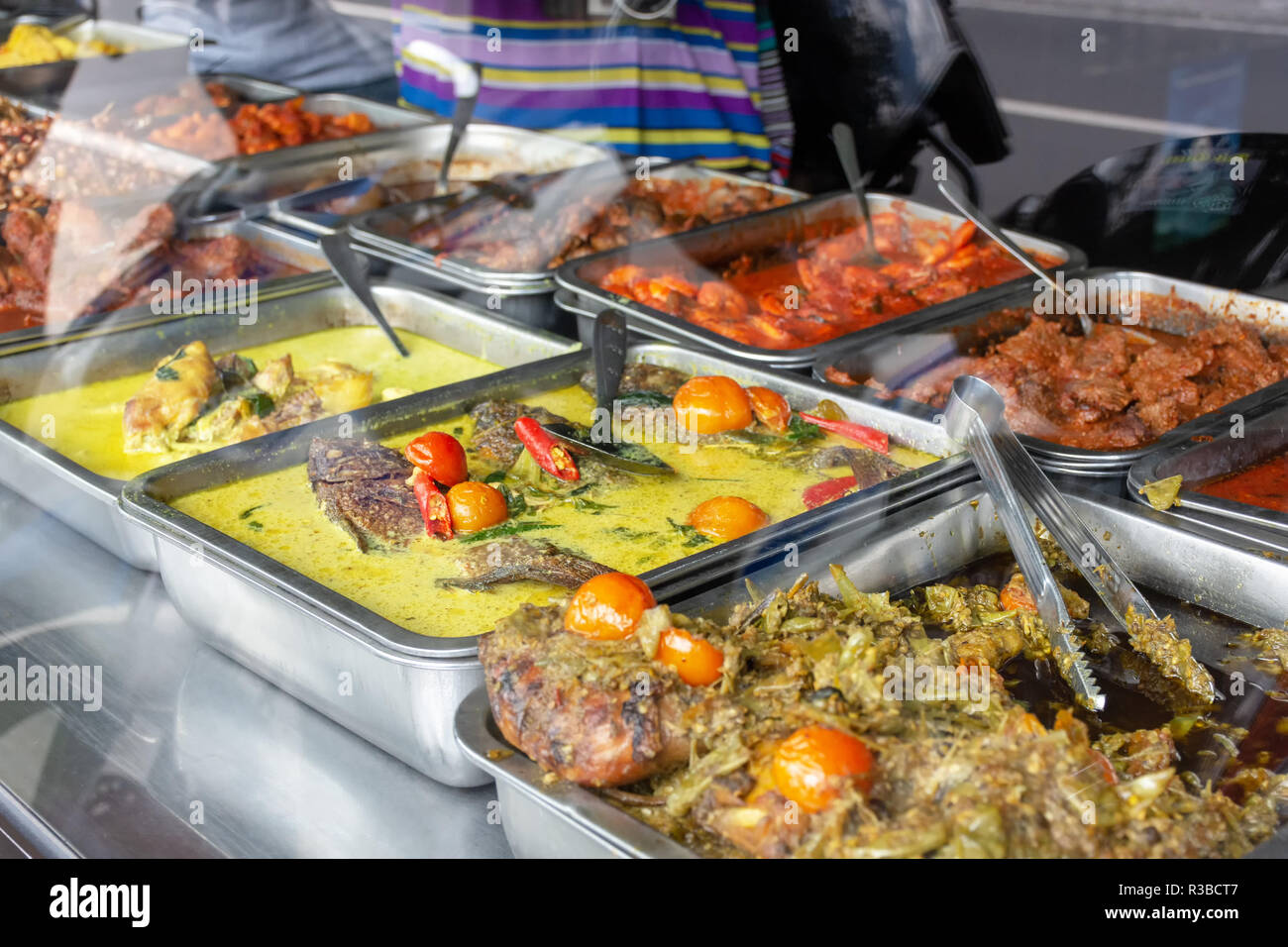 Indonesian food buffet dishes consist of meat, chicken, seafood and vegetables at Javanese restaurant in Bali. Stock Photo