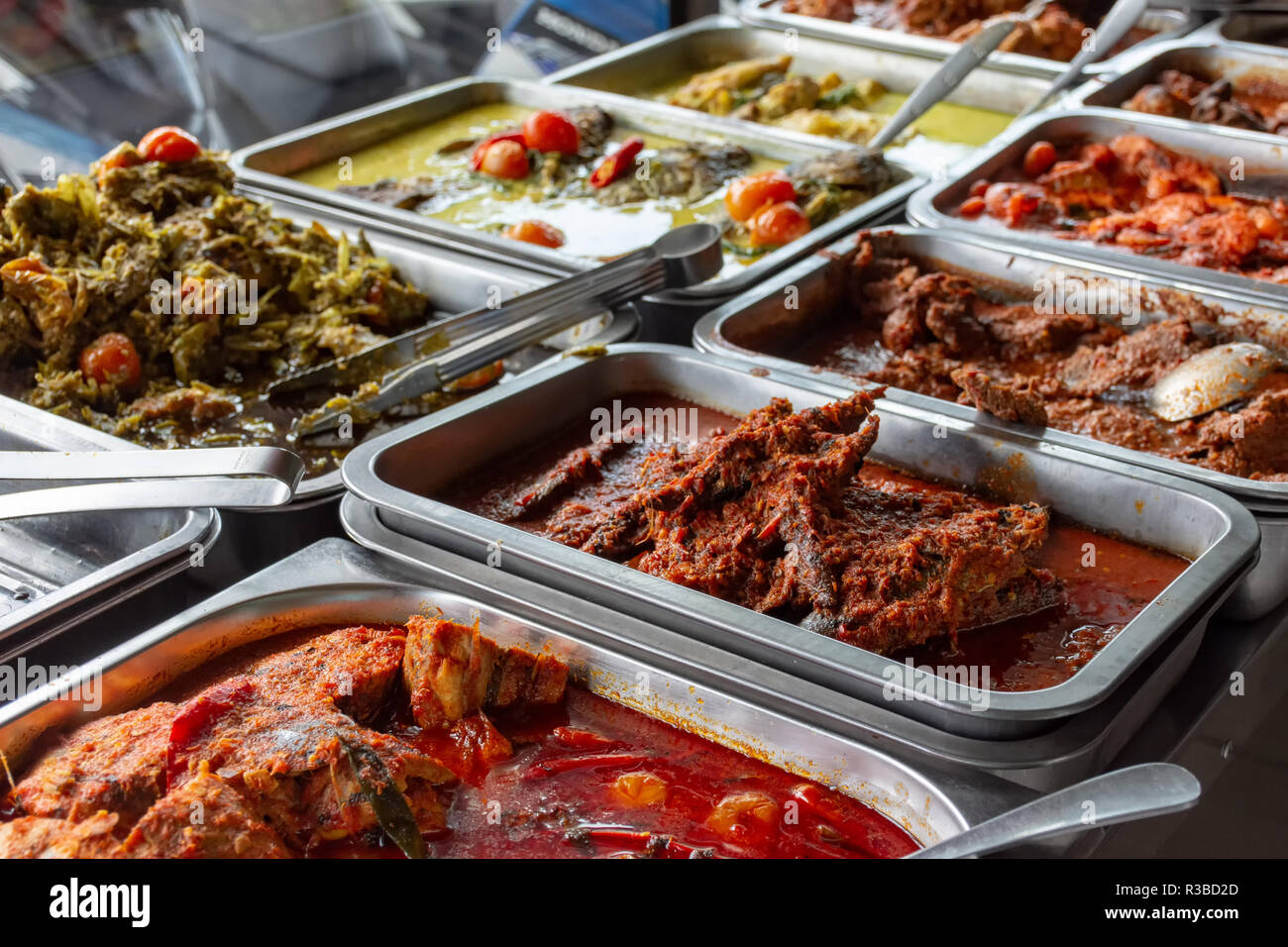 Indonesian food buffet dishes consist of meat, chicken, seafood and vegetables at Javanese restaurant in Bali. Stock Photo