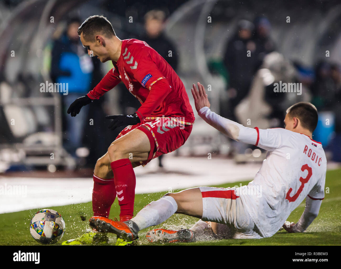 Milan Rodic of Serbia slide tackles Deimantas Petravicius of Lithuania ...