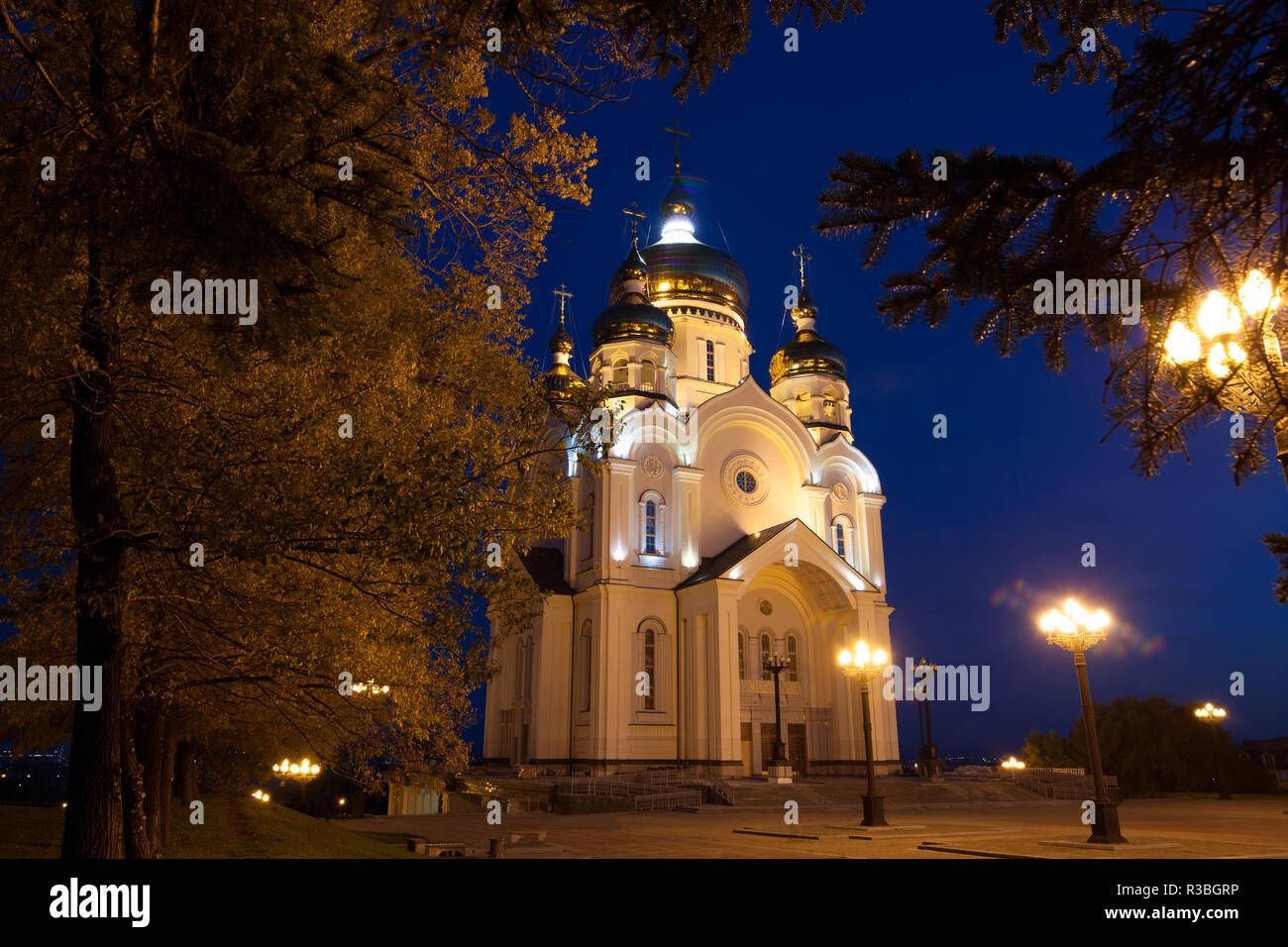 Ortodox cathedral in Khabarovsk, Russia in the night. And autumn trees around it. Stock Photo